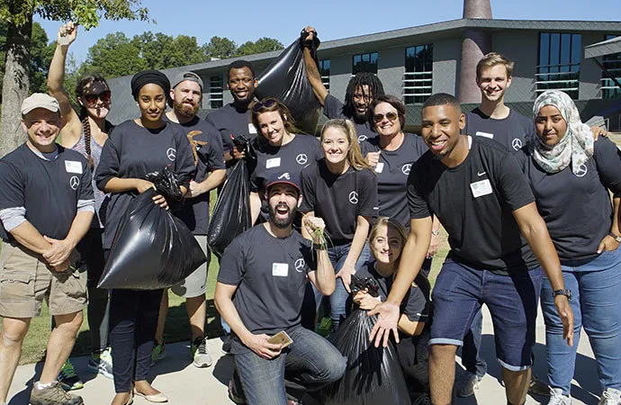 Mercedes-Benz employees enthusiastically help clean up the Fayetteville campus.
