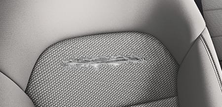 A close-up of a tear in the upholstery of a seat