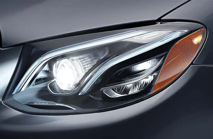 A close-up of a Mercedes-Benz headlight.