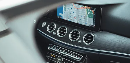 An interior view of a Mercedes-Benz vehicle with the navigation in use.