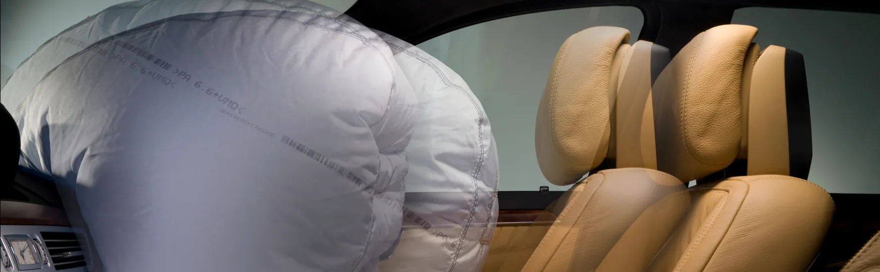 An airbag deploying in front of an empty seat.